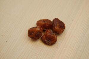 Dates fruit on wooden background. Healthy eating and dieting concept. photo
