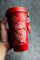 Bangkok, Thailand - June 24, 2024 Reusable cup from Cafe Amazon, Get power to enhance your luck with cup name of Dragon pattern. photo