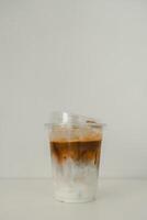 Cold iced latte coffee, showing separate in a layer the bottom as milk top by coffee shot in glass photo
