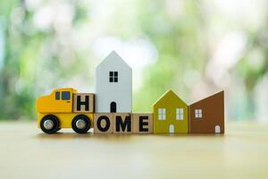Wooden cubes with text HOME with home and car. photo