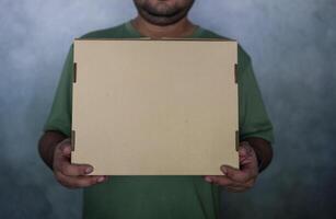 Close up of man with cardboard box parcel photo