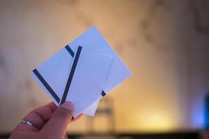 Hands holding an empty white a paper movie ticket. photo