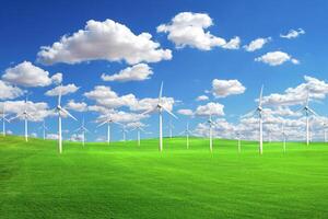 Wind Turbines on a Green Field Under a Blue Sky with White Clouds on a Sunny Day photo