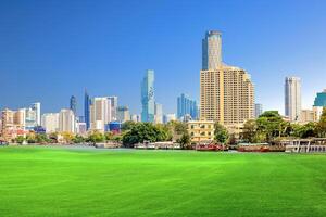 Modern City Skyline with Skyscrapers and Green Park on a Sunny Day photo