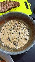 black beans with mushrooms and spices cooked for pasta sauce photo