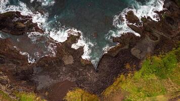 Stunning drone shots of Little Blowhole, Kiama, capturing the intricate rock formations and dynamic waves from a top-down view. Perfect for showcasing Australia's coastal beauty and natural wonders. photo