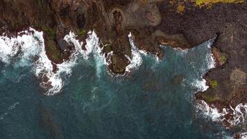Stunning drone shots of Little Blowhole, Kiama, capturing the intricate rock formations and dynamic waves from a top-down view. Perfect for showcasing Australia's coastal beauty and natural wonders. photo