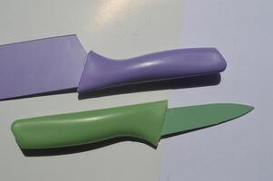 sharp kitchen knives used for cooking, knife set of various shapes and uses put together on a white background photo