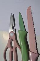 sharp kitchen knives used for cooking, knife set of various shapes and uses put together on a white background photo