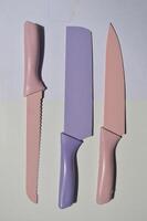 sharp kitchen knives used for cooking, knife set of various shapes and uses put together on a white background photo