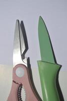 sharp kitchen knives used for cooking, knife set of various shapes and uses put together on a white background photo