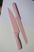 sharp kitchen knives used for cooking, knife set of various shapes and uses put together on a white background photo