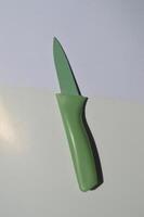 sharp kitchen knives used for cooking, knife set of various shapes and uses put together on a white background photo