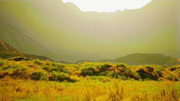 rocky mountain terrain with dry grass and numerous stones. mountain sunset video