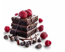 a stack of chocolate brownies with raspberries on top photo
