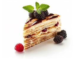 a piece of cake with berries and a mint leaf photo