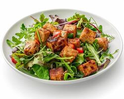 a plate of salad with tofu and vegetables photo