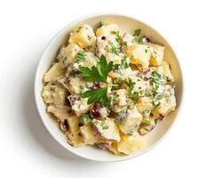 potato salad with bacon and herbs in a bowl photo
