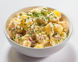 a bowl of potato salad with herbs and cheese photo