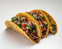 three tacos with meat and vegetables on a white surface photo
