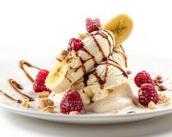 a plate with a banana split, chocolate sauce, and raspberries photo