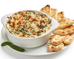 spinach and cheese dip in a white bowl with crackers photo