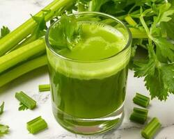 a glass of green juice with celery and celery photo
