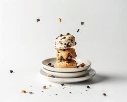 a stack of three plates with chocolate chip cookies photo