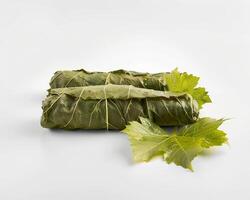 two green leaves are on top of a roll photo