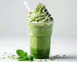 a green smoothie with a straw and mint leaves photo