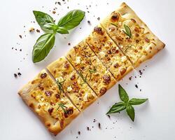 a square piece of pizza with cheese and herbs photo