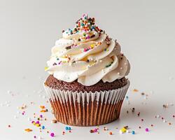 a cupcake with sprinkles on top photo