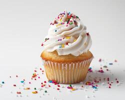 a cupcake with white frosting and sprinkles photo