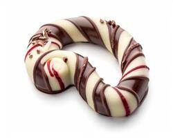 a chocolate covered candy with red and white stripes photo