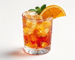 a glass of orange juice with a slice of orange photo