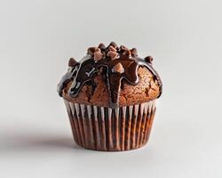 chocolate muffin with chocolate icing on white background photo