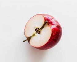 an apple is cut in half on a white surface photo
