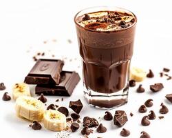 a glass of chocolate shake with bananas and chocolate chips photo