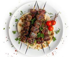 a plate with meat skewers and tomatoes photo