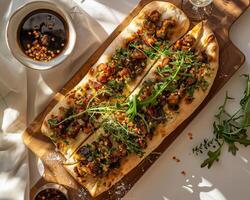 a wooden cutting board with two flatbreads on it photo