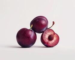 three plums on a white background photo