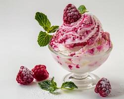 a bowl of ice cream with raspberries and mint leaves photo