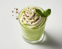 a green smoothie with whipped cream and mint photo