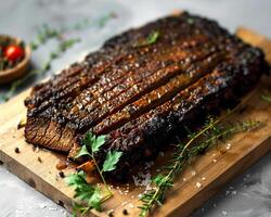 a piece of meat on a cutting board with herbs photo