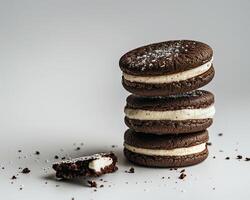 a stack of chocolate cookies with a bite taken out of one photo