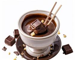 a chocolate hot chocolate with a spoon and some pieces of chocolate photo