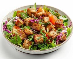 a bowl of salad with tofu, greens and tomatoes photo