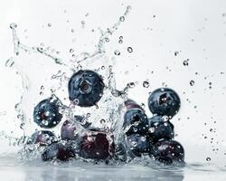 blueberries are splashing into the water photo