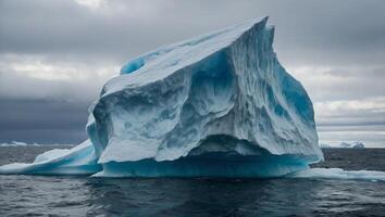A large iceberg floats in the vast ocean waters, showcasing the immense power and beauty of natures icy formations. photo