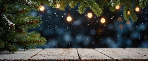 Christmas snowy holiday background with evergreen branches of spruce and empty wooden table top. photo